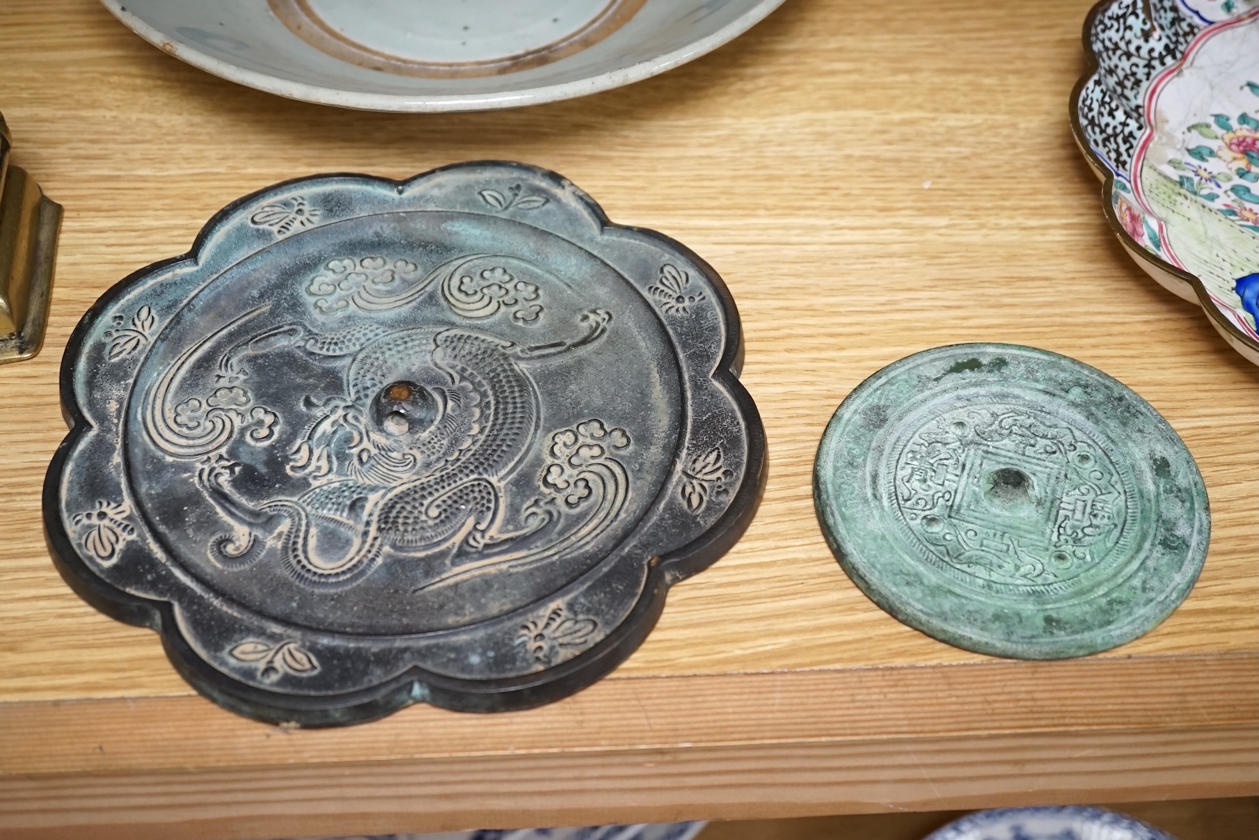 A Chinese archaistic bronze bell, two bronze mirrors, a bronze figure of Nandi, a kitchen Qing dish, and a Japanese antimony vase, largest 27cm in diameter. Condition - mostly fair